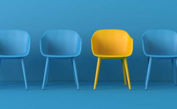 yellow chair among blue chairs